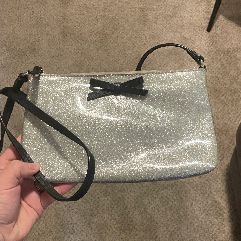 Kate Spade Silver Glitter Wristlet with Black Bow